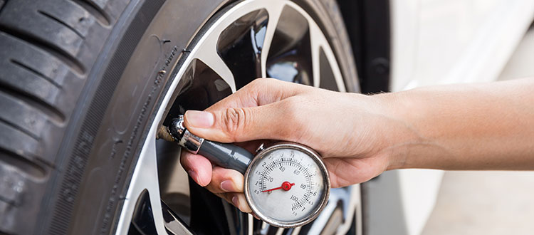 Close-Up Of Hand holding pressure gauge for car tyre pressure me