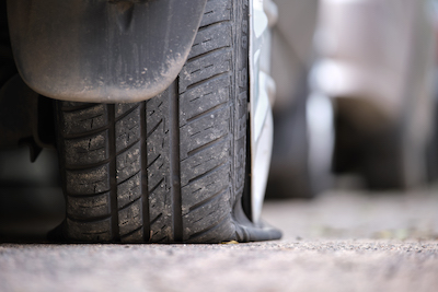close up of a flat car tire